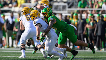 Aug 31, 2024; Eugene, Oregon, USA; Oregon Ducks defensive end Matayo Uiagalelei (10) sacks Idaho Vandals quarterback Jack Layne (2) during the first quarter at Autzen Stadium. Mandatory Credit: Craig Strobeck-USA TODAY Sports