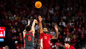 Feb 9, 2025; Lincoln, Nebraska, USA; Ohio State Buckeyes guard John Mobley Jr. (0) shoots a three point basket against Nebraska Cornhuskers guard Brice Williams (3) during the first half at Pinnacle Bank Arena. Mandatory Credit: Dylan Widger-Imagn Images