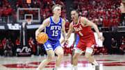 Brigham Young Cougars forward Richie Saunders (15) moves the ball against Utah Utes forward Keanu Dawes (8) during the first half at Jon M. Huntsman Center.