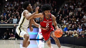Mar 4, 2025; West Lafayette, Indiana, USA; Rutgers Scarlet Knights guard Dylan Harper (2) drives the ball past Purdue Boilermakers forward Trey Kaufman-Renn (4) during the first half at Mackey Arena. Mandatory Credit: Marc Lebryk-Imagn Images