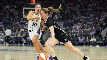 May 16, 2025; San Francisco, California, USA; Golden State Valkyries guard Kate Martin (center) dribbles against Los Angeles Sparks guard Kelsey Plum (10) during the third quarter at Chase Center. Mandatory Credit: Darren Yamashita-Imagn Images