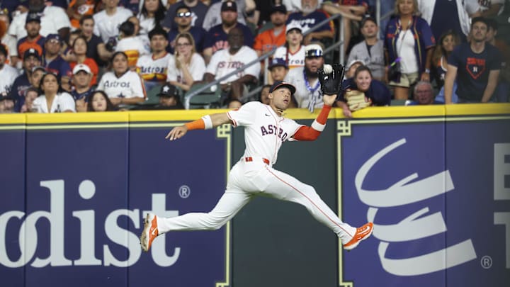Sep 2, 2025; Houston, Texas, USA; Houston Astros right fielder Cam Smith (11) leaps to make a catch during the sixth inning against the New York Yankees at Daikin Park. Mandatory Credit: Troy Taormina-Imagn Images