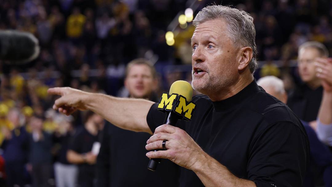 Jan 2, 2026; Ann Arbor, Michigan, USA;  Michigan Wolverines football head coach Kyle Whittingham speaks to the crowd during a time out in the first half against the Southern California Trojans at Crisler Center. Mandatory Credit: Rick Osentoski-Imagn Images