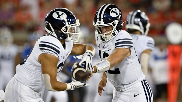 Sep 6, 2024; Dallas, Texas, USA; Brigham Young Cougars running back LJ Martin (27) and quarterback Jake Retzlaff (12) in action during the game between the Southern Methodist Mustangs and the Brigham Young Cougars at Gerald J. Ford Stadium.