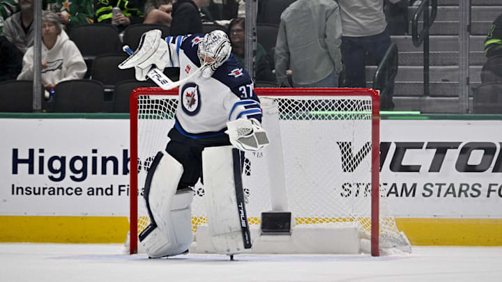 Apr 10, 2025; Dallas, Texas, USA; Winnipeg Jets goaltender Connor Hellebuyck (37) celebrates on the ice after getting the shutout win over the Dallas Stars at the American Airlines Center. Mandatory Credit: Jerome Miron-Imagn Images