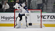 Apr 10, 2025; Dallas, Texas, USA; Winnipeg Jets goaltender Connor Hellebuyck (37) celebrates on the ice after getting the shutout win over the Dallas Stars at the American Airlines Center. Mandatory Credit: Jerome Miron-Imagn Images