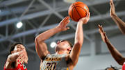 Montverde Academy Eagles guard Dante Allen (30) shoots a lay up while usrrounded by Archbishop Carroll Patriots defenders during the fourth quarter of the first round of the 51st annual City of Palms Classic at Suncoast Credit Union Arena in Fort Myers, Fla., on Wednesday, Dec. 18, 2024.