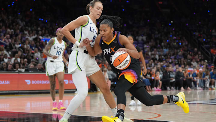 Sep 28, 2025; Phoenix, Arizona, USA; Phoenix Mercury forward Alyssa Thomas (25) drives against Minnesota Lynx forward Alanna Smith (8) in the first half during game four of the second round for the 2025 WNBA Playoffs at PHX Arena. Mandatory Credit: Rick Scuteri-Imagn Images