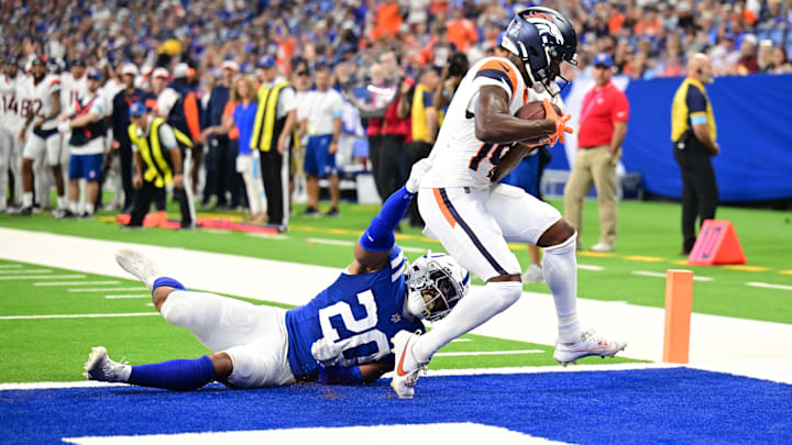 Aug 11, 2024; Indianapolis, Indiana, USA; Denver Broncos wide receiver Marvin Mims Jr. (19) scores a touchdown against Indianapolis Colts safety Nick Cross (20) during the second quarter  at Lucas Oil Stadium. 