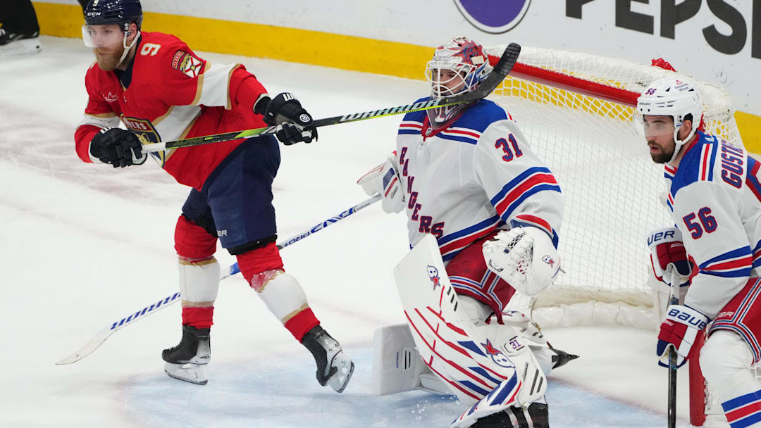 Jun 1, 2024; Sunrise, Florida, USA; The stick of Florida Panthers center Sam Bennett (9) collides with New York Rangers goaltender Igor Shesterkin (31) during the second period in game six of the Eastern Conference Final of the 2024 Stanley Cup Playoffs at Amerant Bank Arena. Mandatory Credit: Jim Rassol-Imagn Images