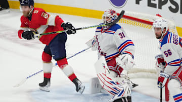 Jun 1, 2024; Sunrise, Florida, USA; The stick of Florida Panthers center Sam Bennett (9) collides with New York Rangers goaltender Igor Shesterkin (31) during the second period in game six of the Eastern Conference Final of the 2024 Stanley Cup Playoffs at Amerant Bank Arena. Mandatory Credit: Jim Rassol-Imagn Images