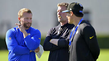 Jul 29, 2024; Los Angeles, CA, USA; Los Angeles Rams head coach Sean McVay, general manager Les Snead and chief of staff Carter Crutchfield talk on the field during training camp at Loyola Marymount University. Mandatory Credit: Jayne Kamin-Oncea-Imagn Images