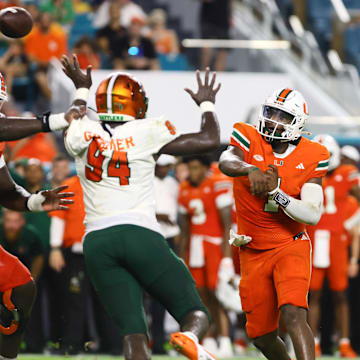 Sep 7, 2024; Miami Gardens, Florida, USA; Miami Hurricanes quarterback Cam Ward (1) passes the football against the Florida A&M Rattlers during the third quarter at Hard Rock Stadium. Mandatory Credit: Sam Navarro-Imagn Images