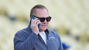 Apr 14, 2025; Los Angeles, California, USA; Sports agent Scott Boras talks on a cell phone before a game between the Colrorado Rockies and Los Angeles Dodgers at Dodger Stadium. Mandatory Credit: Kirby Lee-Imagn Images