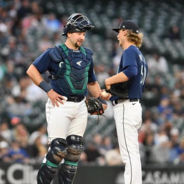 Seattle Mariners catcher Cal Raleigh (29) and starting pitcher Bryce Miller (50) interact during the sixth inning against the Oakland Athletics at T-Mobile Park on May 24.