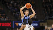 Feb 11, 2025; Morgantown, West Virginia, USA; Brigham Young Cougars guard Egor Demin (3) looks to pass while defended by West Virginia Mountaineers guard KJ Tenner (3) during the second half at WVU Coliseum. Mandatory Credit: Ben Queen-Imagn Images