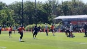 Caleb Williams rolls out and throws during training camp practice Day 5 Thursday at Halas Hall.