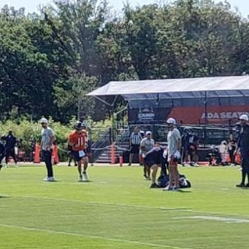 Caleb Williams rolls out and throws during training camp practice Day 5 Thursday at Halas Hall.