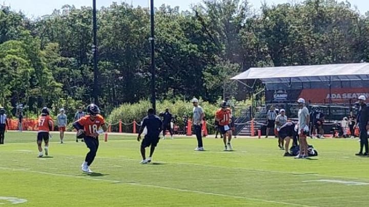 Caleb Williams rolls out and throws during training camp practice Day 5 Thursday at Halas Hall.