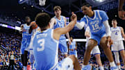 Dec 2, 2025; Lexington, Kentucky, USA; North Carolina Tar Heels guard Derek Dixon (3) is helped to his feet by center Henri Veesaar (13) and forward Jarin Stevenson (15) during the first half against the Kentucky Wildcats at Rupp Arena at Central Bank Center. Mandatory Credit: Jordan Prather-Imagn Images