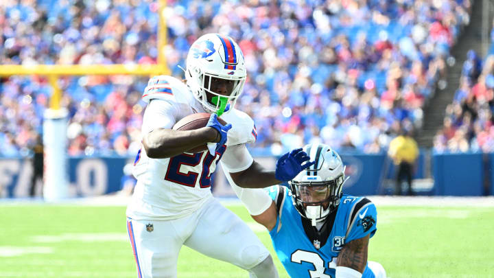 Aug 24, 2024; Orchard Park, New York, USA; Buffalo Bills running back Frank Gore Jr. (20) tries to break a tackle by Carolina Panthers cornerback Lamar Jackson (31) in the third quarter pre-season game at Highmark Stadium. Mandatory Credit: Mark Konezny-USA TODAY Sports