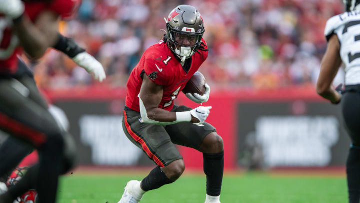 Dec 24, 2023; Tampa, Florida, USA; Tampa Bay Buccaneers running back Rachaad White (1) runs the ball after the Jacksonville Jaguars in the second quarter at Raymond James Stadium. Mandatory Credit: Jeremy Reper-USA TODAY Sports