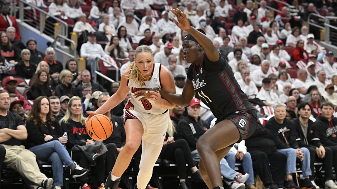 Dec 4, 2025; Louisville, Kentucky, USA; Louisville Cardinals forward Laura Ziegler (0) drives to the basket against South Carolina Gamecocks center Madina Okot (11) during the first half at KFC Yum! Center. Mandatory Credit: Jamie Rhodes-Imagn Images Dec 4, 2025; Louisville, Kentucky, USA; Louisville Cardinals forward Laura Ziegler (0) drives to the basket against South Carolina Gamecocks center Madina Okot (11) during the first half at KFC Yum! Center. Mandatory Credit: Jamie Rhodes-Imagn Images
