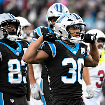 Dec 22, 2024; Charlotte, North Carolina, USA;  Carolina Panthers running back Chuba Hubbard (30) reacts after running for a first down in overtime at Bank of America Stadium. Mandatory Credit: Bob Donnan-Imagn Images