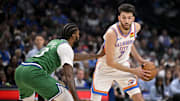Oct 27, 2025; Dallas, Texas, USA; Oklahoma City Thunder center Chet Holmgren (7) looks to move the ball past Dallas Mavericks forward Naji Marshall (13) during the second quarter at the American Airlines Center. Mandatory Credit: Jerome Miron-Imagn Images