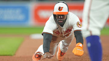 Apr 15, 2025; Baltimore, Maryland, USA; Baltimore Orioles outfielder Cedric Mullins (42) dives back safely to first base following a fourth inning pickoff attempt against the Cleveland Guardians at Oriole Park at Camden Yards. 