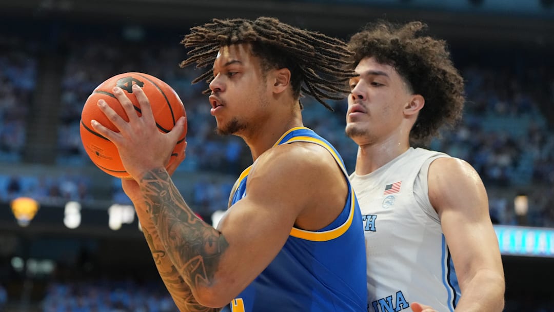 Feb 14, 2026; Chapel Hill, North Carolina, USA; Pittsburgh Panthers forward Cameron Corhen (2) with the ball as North Carolina Tar Heels forward Zayden High (1) defends in the first half at Dean E. Smith Center. Mandatory Credit: Bob Donnan-Imagn Images