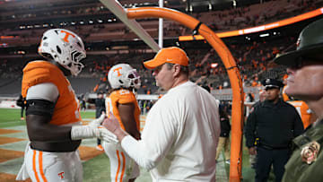 Tennessee football coach Josh Heupel encourages offensive lineman David Sanders Jr. (70) as he returns to the locker room after losing to Vanderbilt in NCAA college football game on Nov. 29, 2025, in Knoxville, Tennessee.
