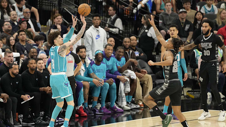 Mar 14, 2025; San Antonio, Texas, USA; Charlotte Hornets guard LaMelo Ball (1) shoots over San Antonio Spurs guard Devin Vassell (24) during the second half at Frost Bank Center. Mandatory Credit: Scott Wachter-Imagn Images