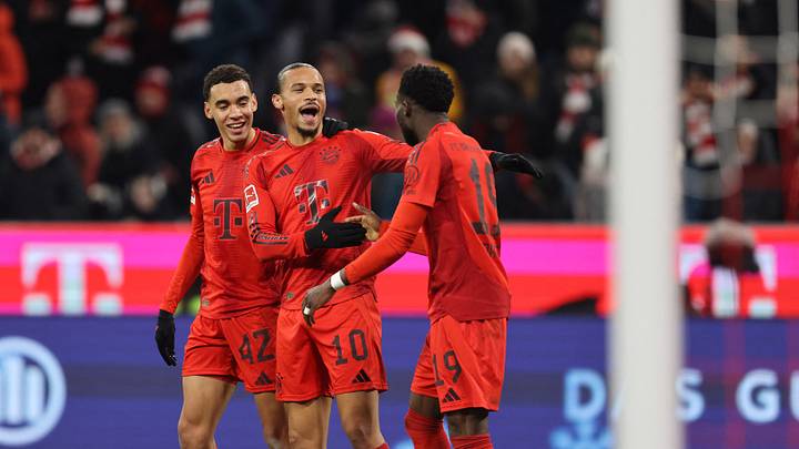 Bayern Munich stars Jamal Musiala, Leroy Sane, and Alphonso Davies celebrate against RB Leipzig.