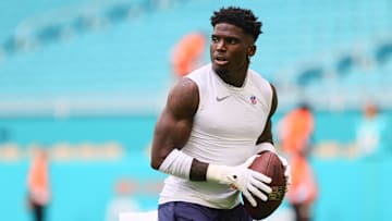 Aug 17, 2024; Miami Gardens, Florida, USA; Miami Dolphins wide receiver Tyreek Hill (10) throws the football before preseason game against the Washington Commanders at Hard Rock Stadium.