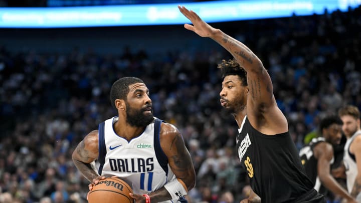 Jan 9, 2024; Dallas, Texas, USA; Dallas Mavericks guard Kyrie Irving (11) looks to shoot the ball over Memphis Grizzlies guard Marcus Smart (36) during the first quarter at the American Airlines Center. Mandatory Credit: