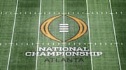 The College Football Playoff National Championship logo at midfield at Mercedes-Benz Stadium.