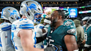 Both former University of Michigan players, Detroit Lions defensive end Aidan Hutchinson (97), left, talks to Philadelphia Eagles defensive end Brandon Graham (55) after the Detroit Lions lost 16-9 to the Philadelphia Eagles at Lincoln Financial Field in Philadelphia on Sunday, November 16, 2025.