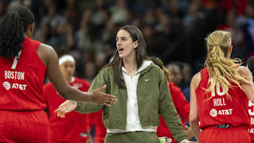Aug 24, 2025; Minneapolis, Minnesota, USA; Indiana Fever guard Caitlin Clark (22) shakes hands with Indiana Fever forward Aliyah Boston (7) and Indiana Fever guard Lexie Hull (10) during a timeout against the Minnesota Lynx in the first half at Target Center. Mandatory Credit: Jesse Johnson-Imagn Images