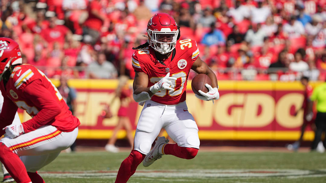 Aug 17, 2024; Kansas City, Missouri, USA; Kansas City Chiefs running back Keaontay Ingram (30) runs the ball against the Detroit Lions during the first half at GEHA Field at Arrowhead Stadium. Mandatory Credit: Denny Medley-Imagn Images