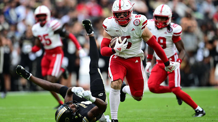 Sep 28, 2024; West Lafayette, Indiana, USA; Nebraska Cornhuskers linebacker John Bullock (5) runs the ball for a touchdown after an interception against the Purdue Boilermakers during the second half at Ross-Ade Stadium. Credit: Marc Lebryk-Imagn Images Sep 28, 2024; West Lafayette, Indiana, USA; Nebraska Cornhuskers linebacker John Bullock (5) runs the ball for a touchdown after an interception against the Purdue Boilermakers during the second half at Ross-Ade Stadium. Credit: Marc Lebryk-Imagn Images