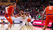 Jan 25, 2025; Blacksburg, Virginia, USA; Virginia Tech Hokies guard Rodney Brown Jr. (4) shoots the ball against Clemson Tigers center Viktor Lakhin (0) during the first half at Cassell Coliseum. Mandatory Credit: Peter Casey-Imagn Images