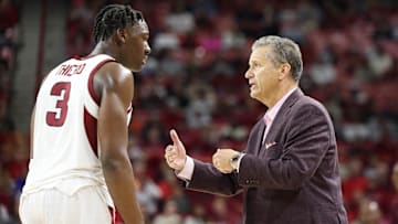 Nov 22, 2024; Fayetteville, Arkansas, USA; Arkansas Razorbacks head coach John Calipari talks to forward Adou Thiero (3) during the second half against the Little Rock Trojans at Bud Walton Arena. Arkansas won 79-67. Mandatory Credit: Nelson Chenault-Imagn Images
