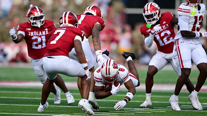 Nov 15, 2025; Bloomington, Indiana, USA; Wisconsin Badgers wide receiver Vinny Anthony II (8) dives in front of Indiana Hoosiers defensive back Amare Ferrell (1) during the first quarter at Memorial Stadium. Mandatory Credit: Marc Lebryk-Imagn Images