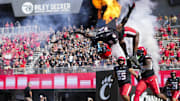 Oct 4, 2025; Cincinnati, Ohio, USA;  Cincinnati Bearcats safety Marqavious Saboor (18) does a flip during player introductions before the game against the Iowa State Cyclones at Nippert Stadium. Mandatory Credit: Aaron Doster-Imagn Images