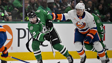 Oct 12, 2024; Dallas, Texas, USA; Dallas Stars center Colin Blackwell (15) passes the puck in front of New York Islanders right wing Maxim Tsyplakov (7) during the second period at the American Airlines Center. Mandatory Credit: Jerome Miron-Imagn Images