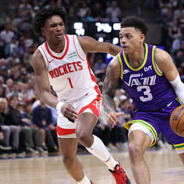 Apr 11, 2024; Salt Lake City, Utah, USA; Utah Jazz guard Keyonte George (3) drives against Houston Rockets forward Amen Thompson (1) during the second quarter at Delta Center. Mandatory Credit: Rob Gray-Imagn Images