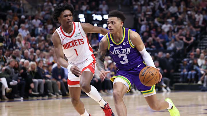 Apr 11, 2024; Salt Lake City, Utah, USA; Utah Jazz guard Keyonte George (3) drives against Houston Rockets forward Amen Thompson (1) during the second quarter at Delta Center. Mandatory Credit: Rob Gray-Imagn Images