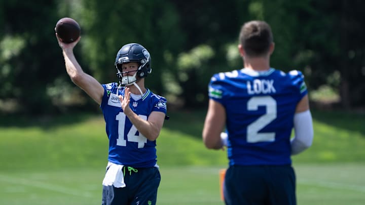 Seattle Seahawks quarterback Sam Darnold passes the ball to quarterback Drew Lock
