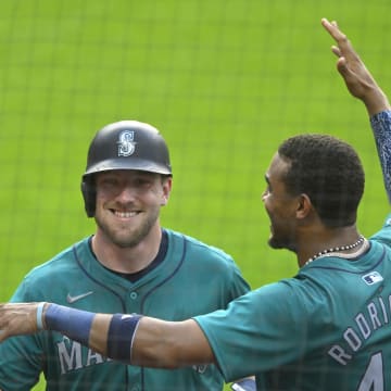 Seattle Mariners left fielder Luke Raley (20) celebrates his solo home run with center fielder Julio Rodriguez (44) in the fifth inning against the Cleveland Guardians at Progressive Field on June 18.
